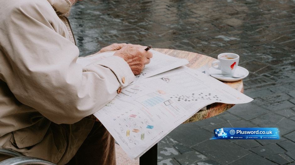 A person writing down daily word puzzle tips in a notebook next to a cup of coffee.