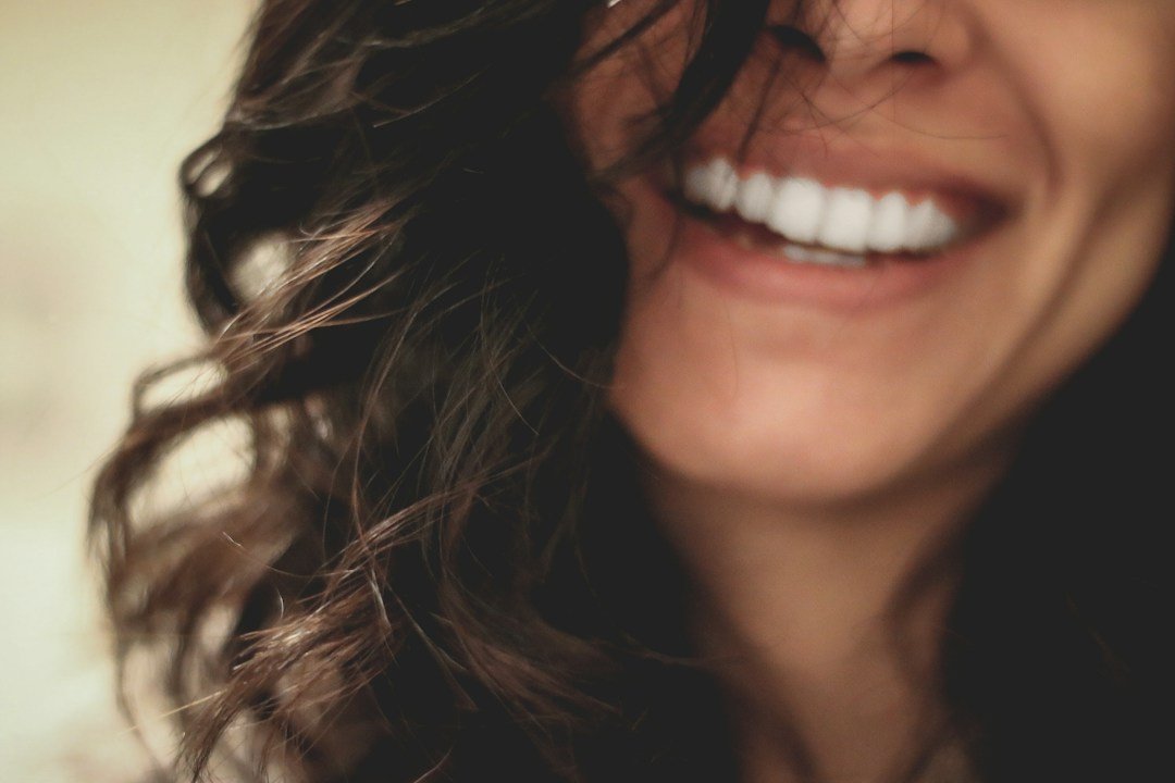 Smiling person showing teeth for a whitening and smile care guide